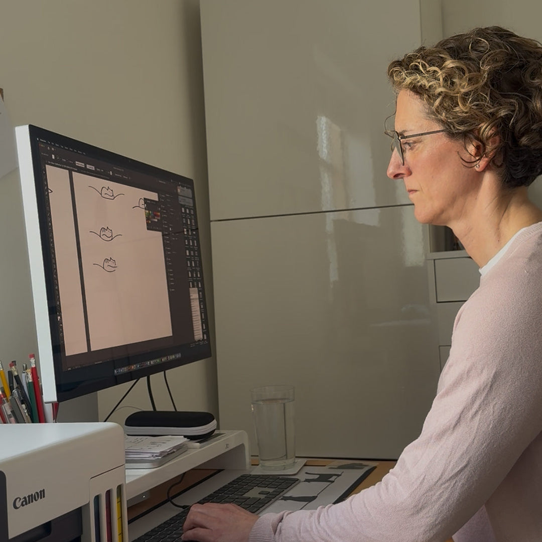 Jinny at her desk sketching the Cat Companions collection designs