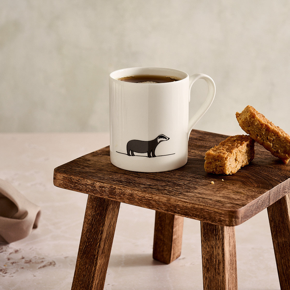 Badger Mug on wooden stool with flapjacks