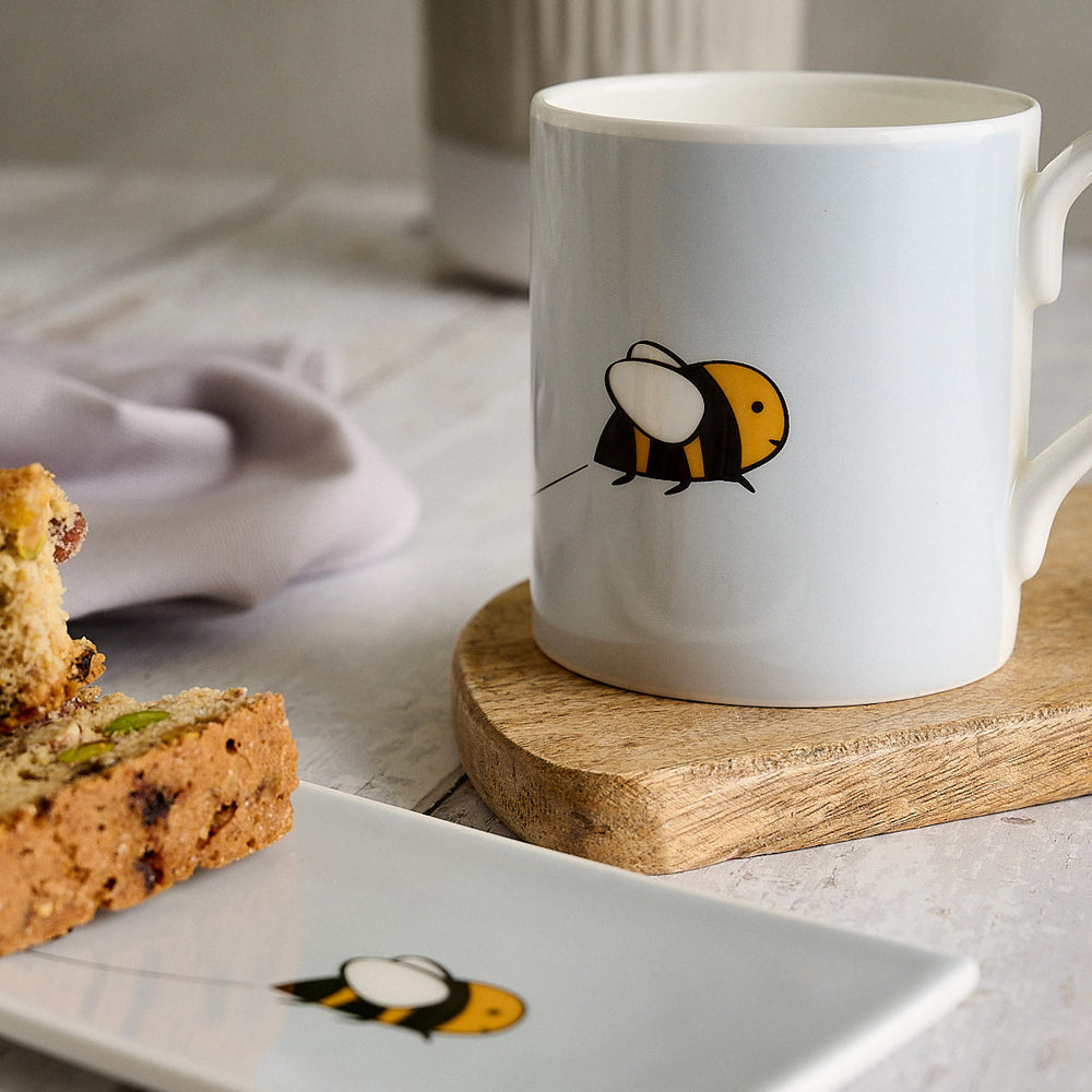 Bee Mug by Jin Designs with shortbread biscuits on a kitchen table