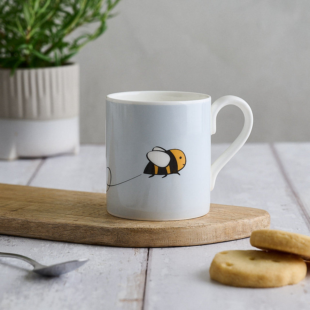 Bee Mug by Jin Designs with shortbread biscuits on a kitchen table