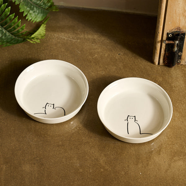 Two white fine bone china cat bowls with Loafing Cat and Waiting Cat