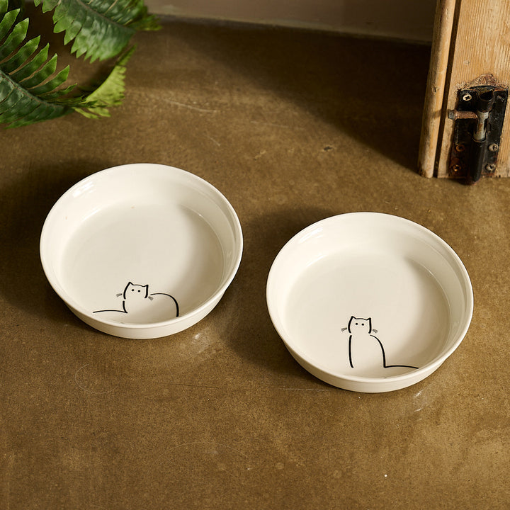 Two white fine bone china cat bowls with Loafing Cat and Waiting Cat