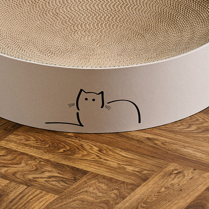 Close up of special edition CatLoaf round cat scratcher featuring Loafing Cat - placed on a wooden parquet floor.