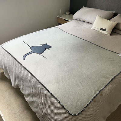 Crouching Cat Blanket on bed