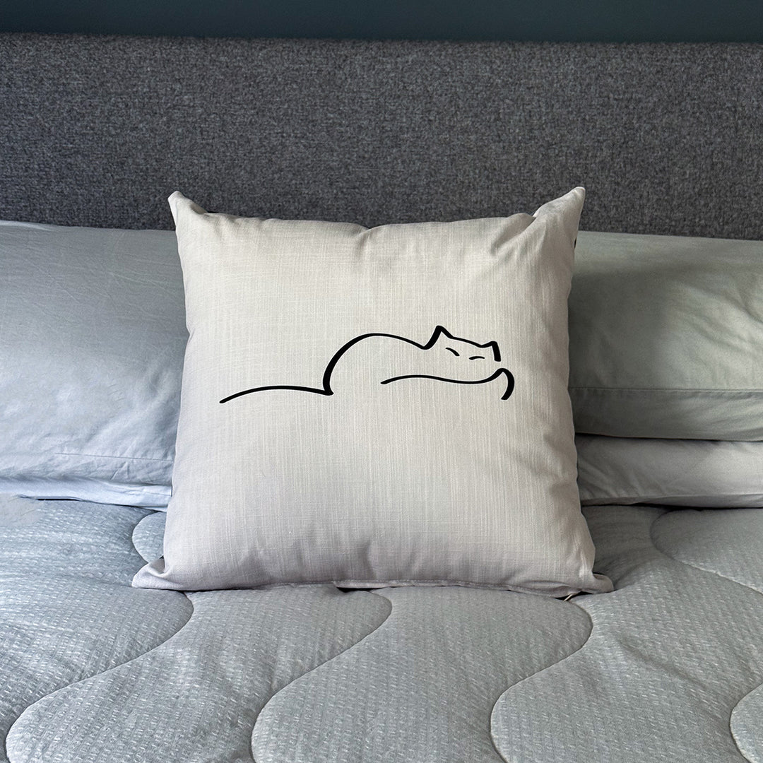 Dreaming Cat Cushion on bed