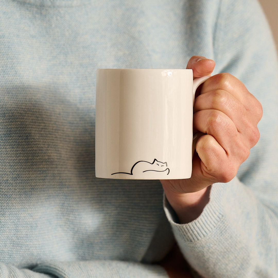 Dreaming Cat Mug in hand