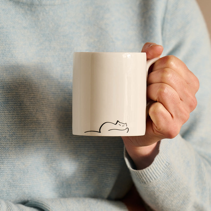 Dreaming Cat Mug in hand