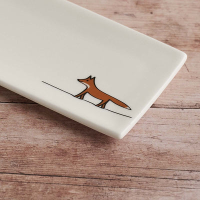 Rectangular white mini tray with a brown fox illustration on a wooden surface