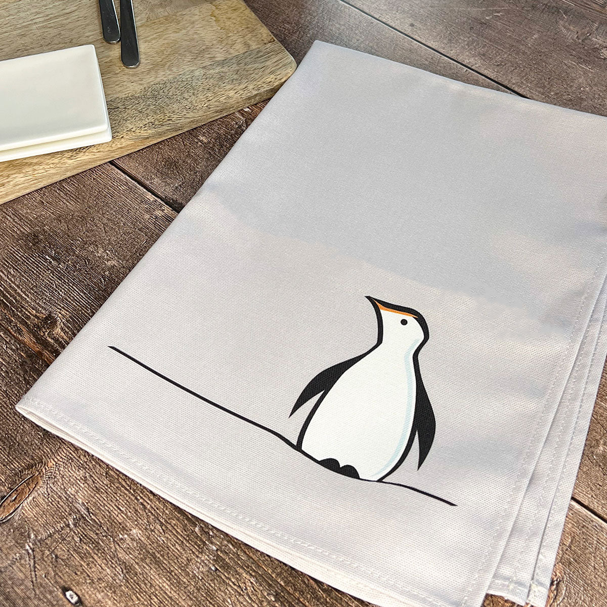 Penguin Tea Towel on table