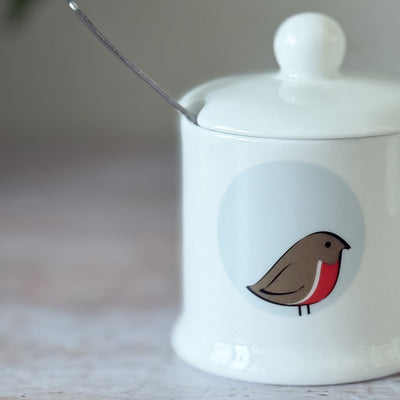 White fine bone china jam pot with Robin design on a wooden surface
