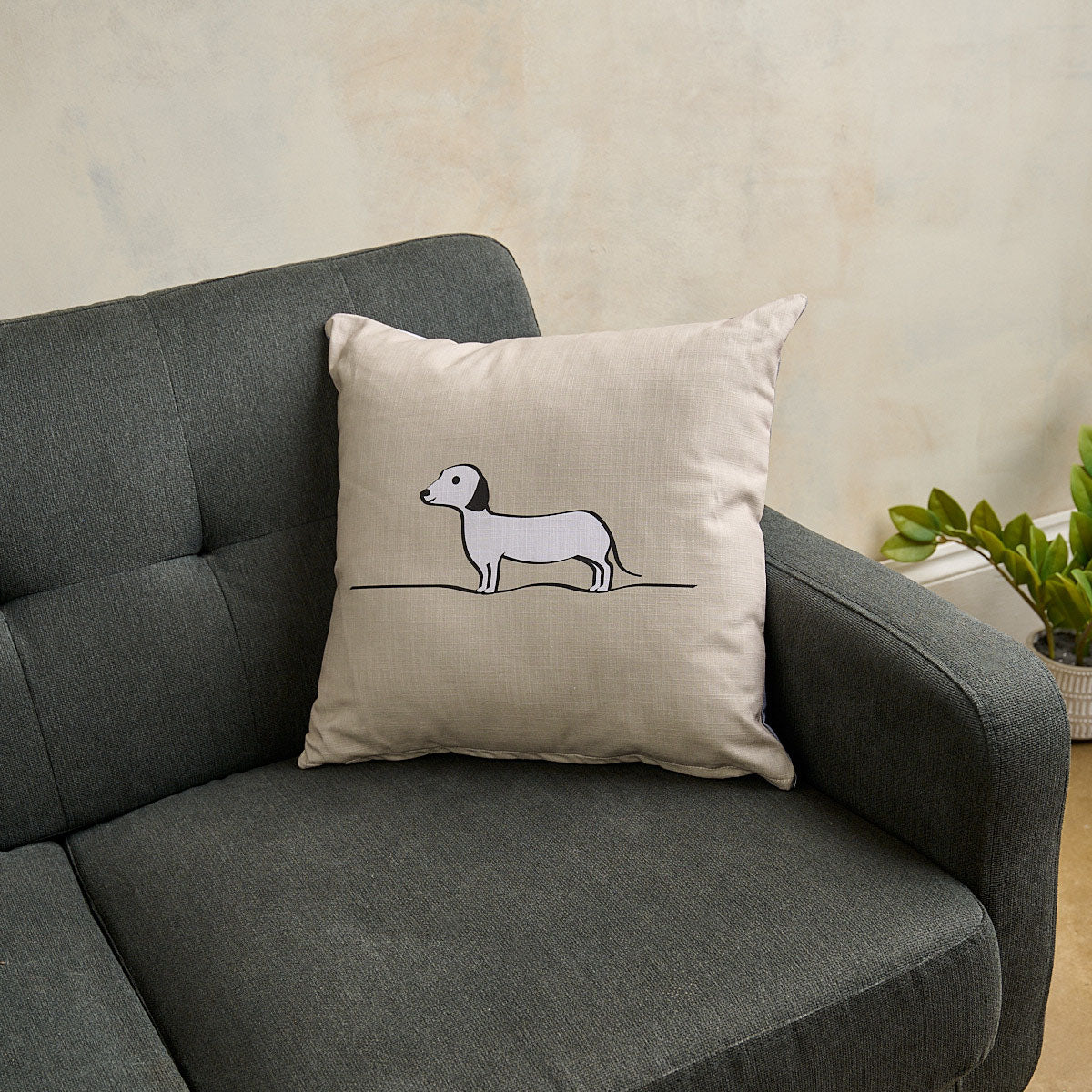 Sausage Dog Cushion on Grey Sofa