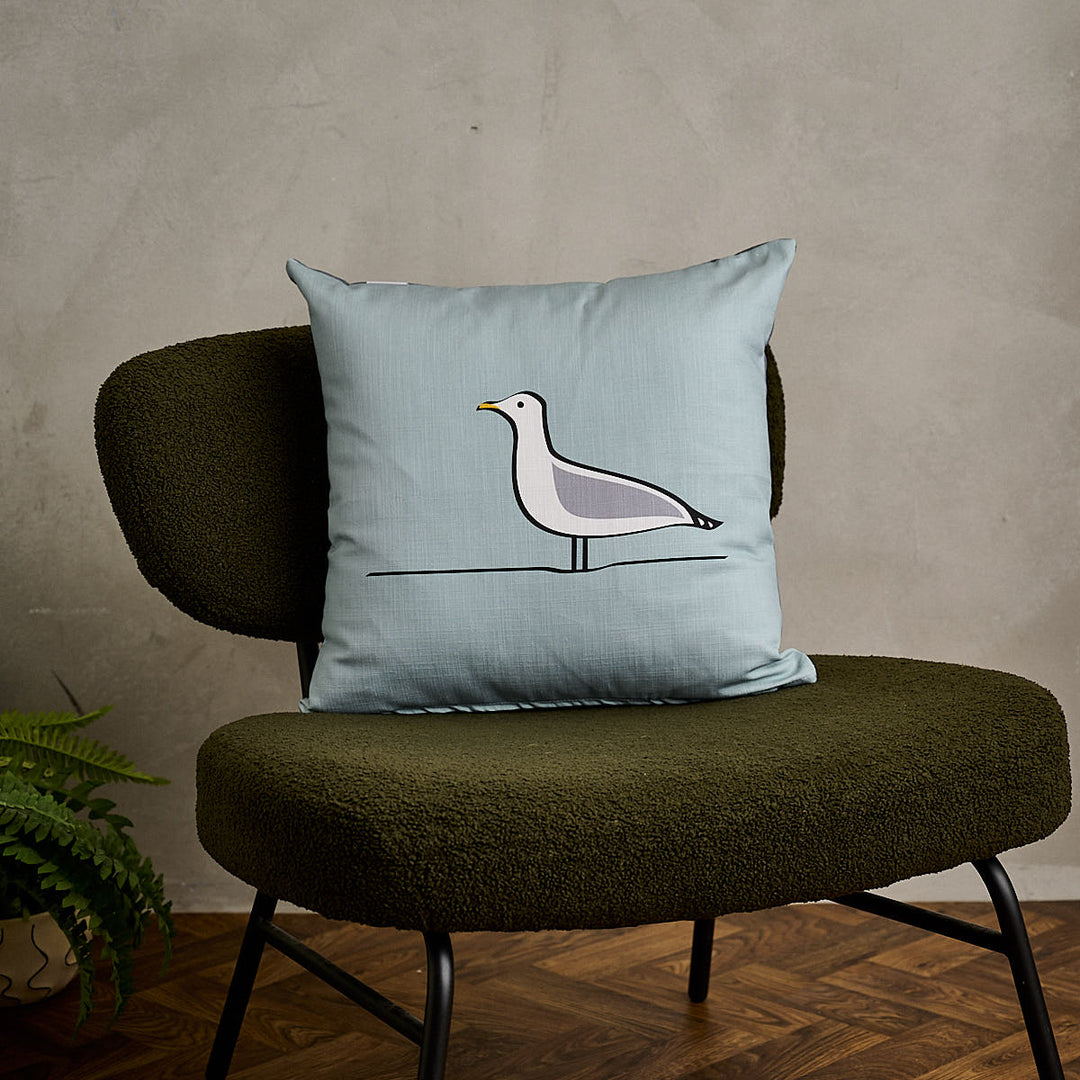 Seagull Cushion on green sofa chair