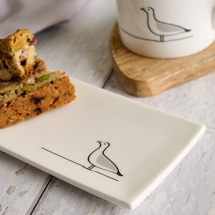 Seagull Mini Tray with biscotti and Seagull Mug on white wooden table