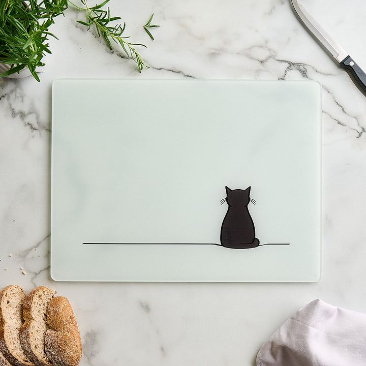 Sitting Cat Glass Worktop Saver with sliced bread and herbs