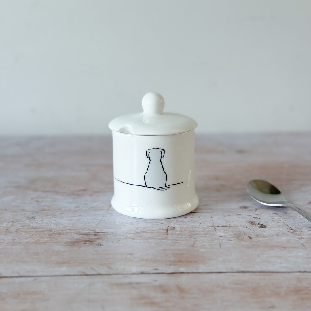 White fine bone china jam pot with Sitting Dog illustration on a wooden surface