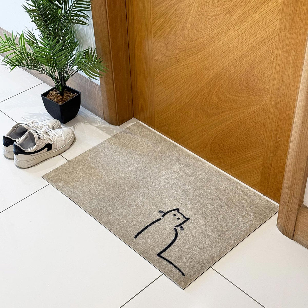 Waiting Cat Doormat in hallway with shoes and plant