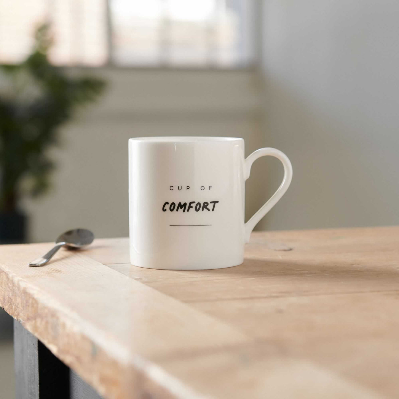 Cup of Comfort Mug on table