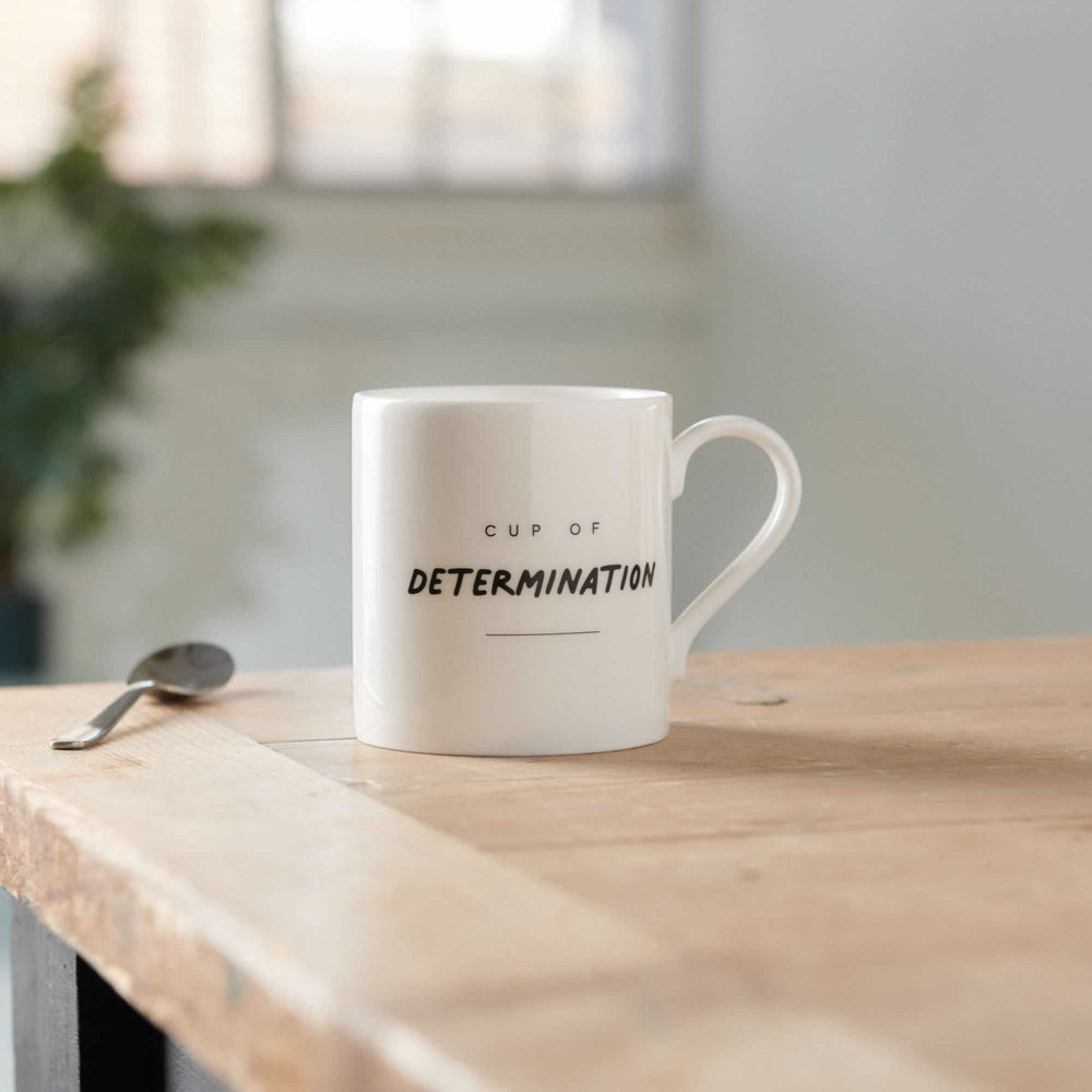 Cup of Determination Mug on table