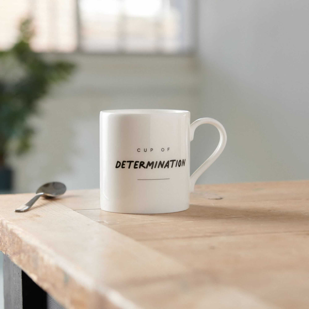 Cup of Determination Mug on table