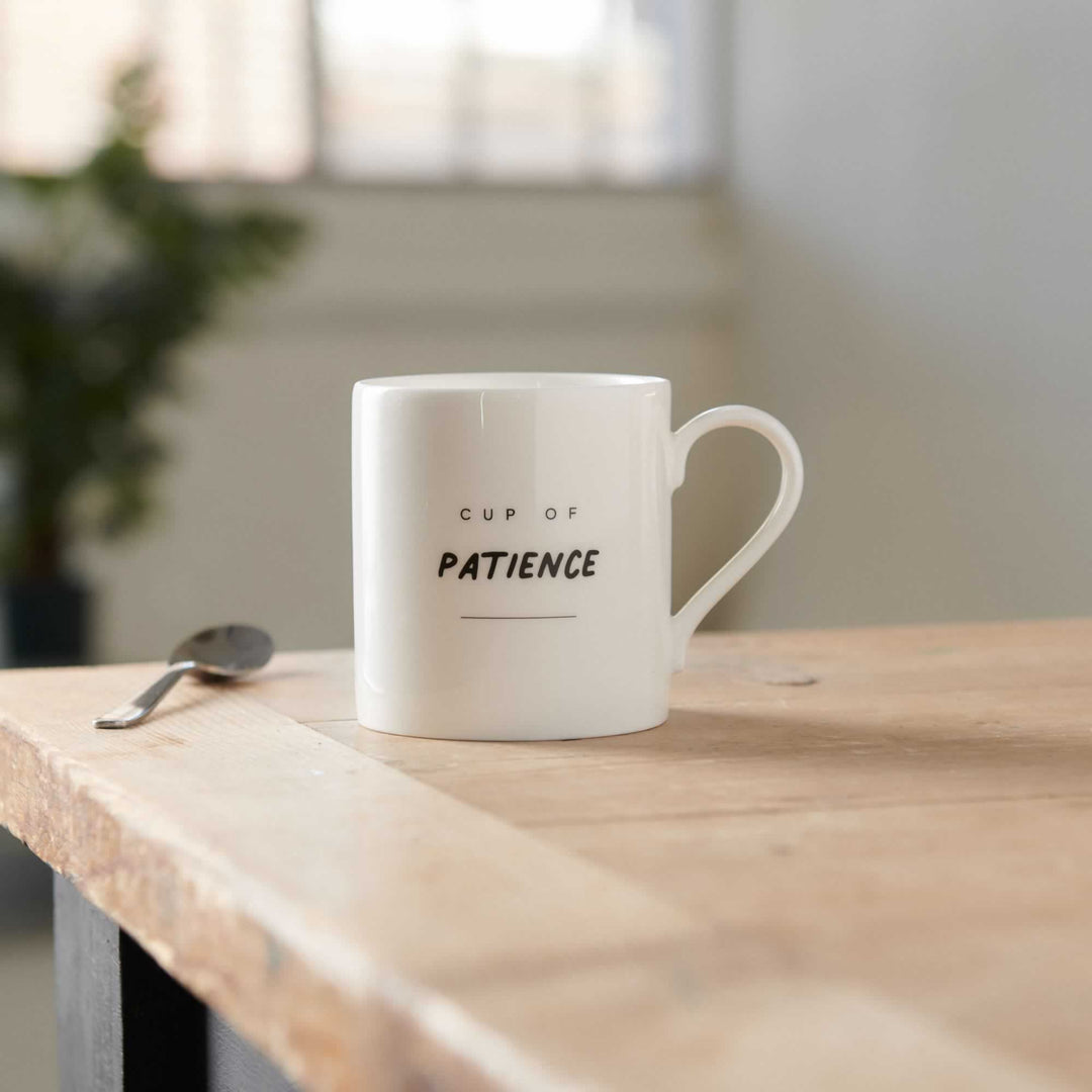 Cup of Patience Mug on table