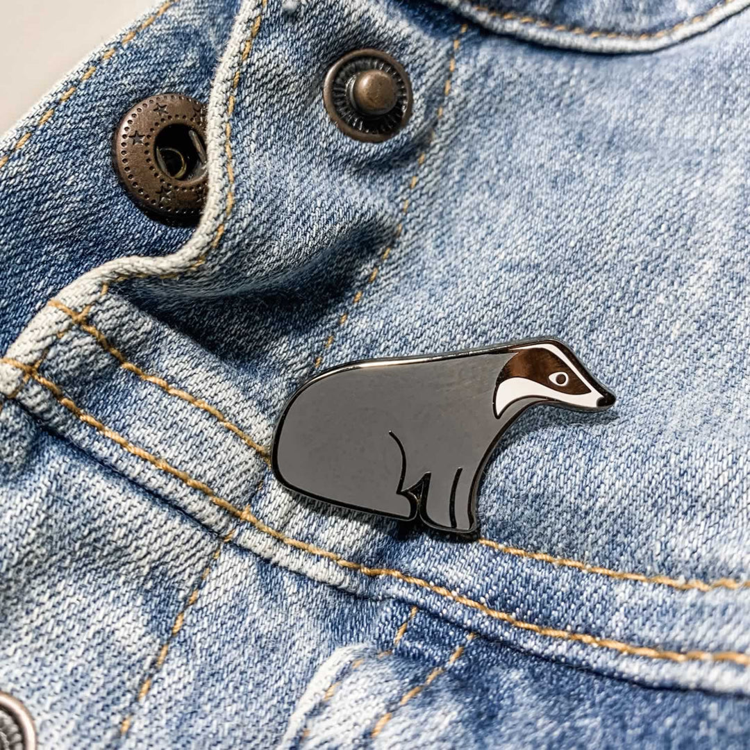 Badger Enamel Pin on Denim