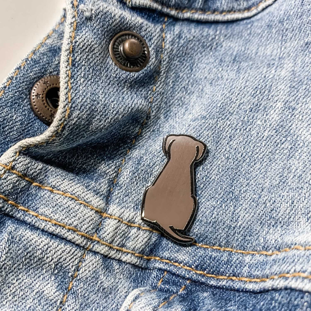 Sitting Dog Enamel Pin on Denim