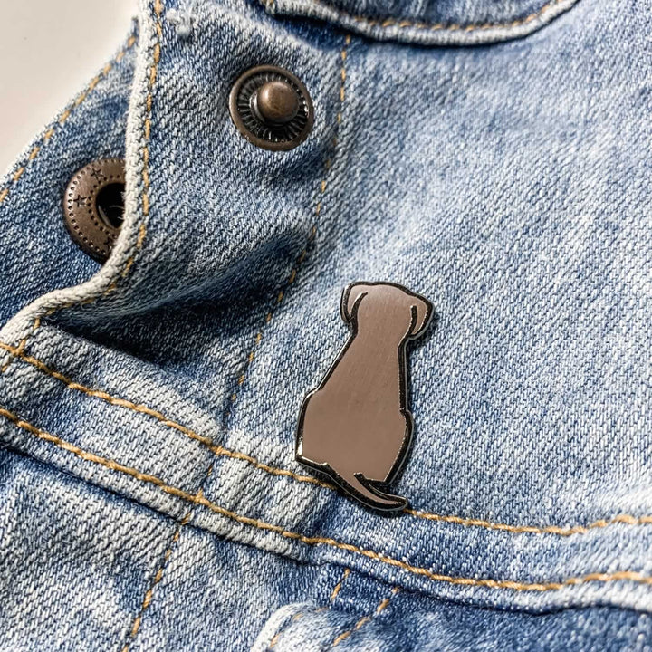 Sitting Dog Enamel Pin on Denim